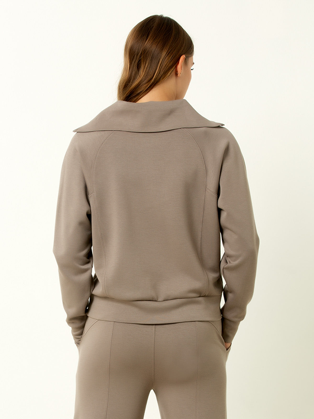 back shot of female model wearing walnut colored pullover sweatshirt.
