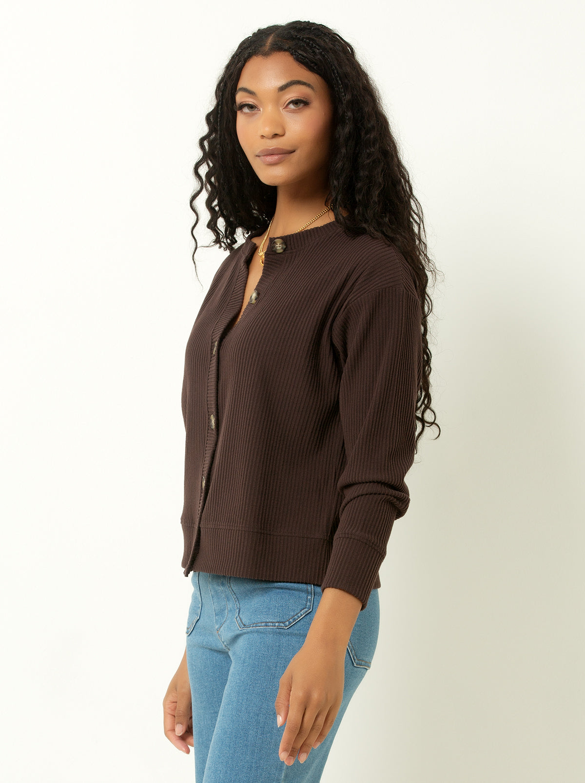 female model wearing a brown colored ribbed cardigan sweater with buttons