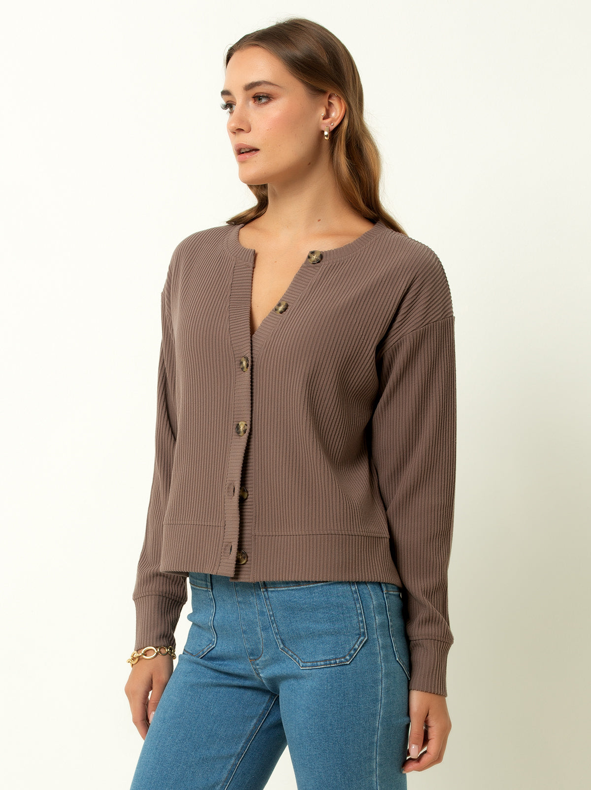 female model wearing a walnut colored ribbed cardigan sweater with buttons