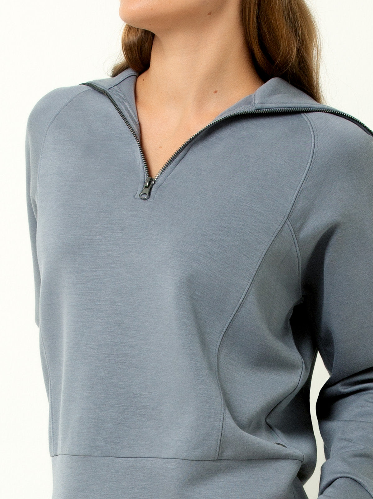 close up shot of female model quarter zip blue gray colored pullover sweatshirt