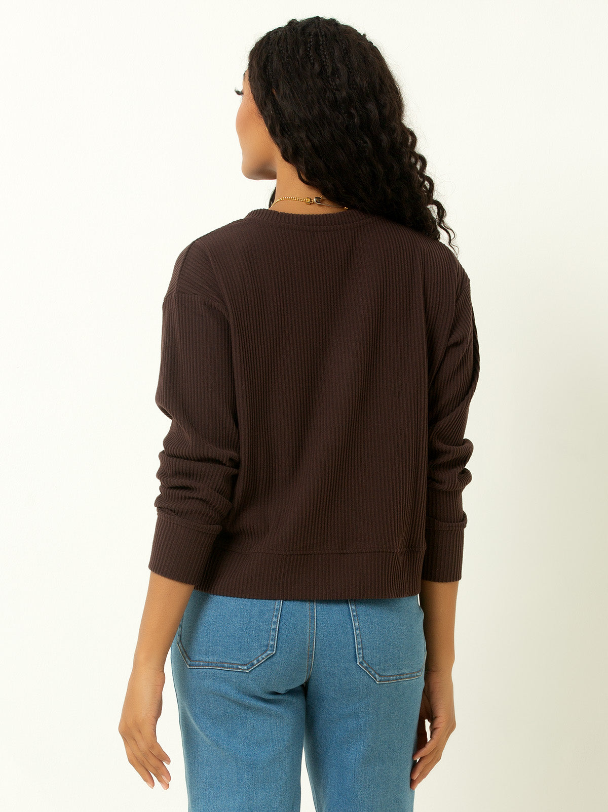 back shot of female model wearing a brown colored ribbed cardigan sweater with buttons