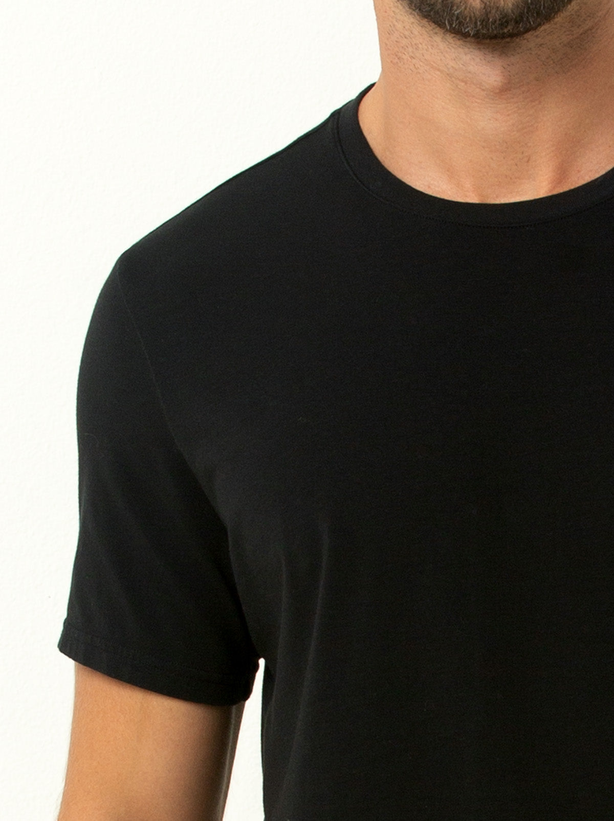 close up shot of male model wearing black colored crew neck tee