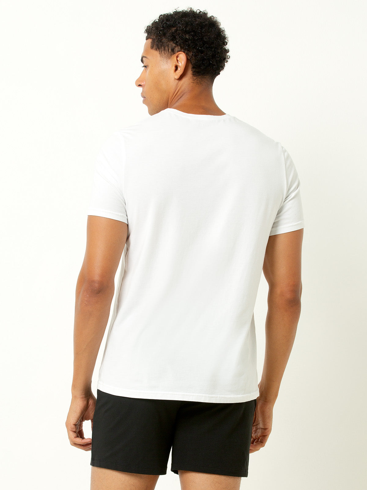 back shot of male model wearing white colored crew neck tee