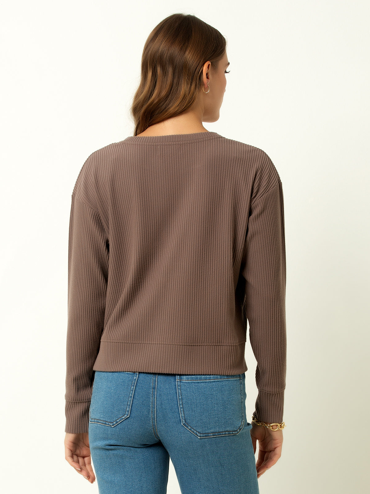 back shot of female model wearing a walnut colored ribbed cardigan sweater with buttons