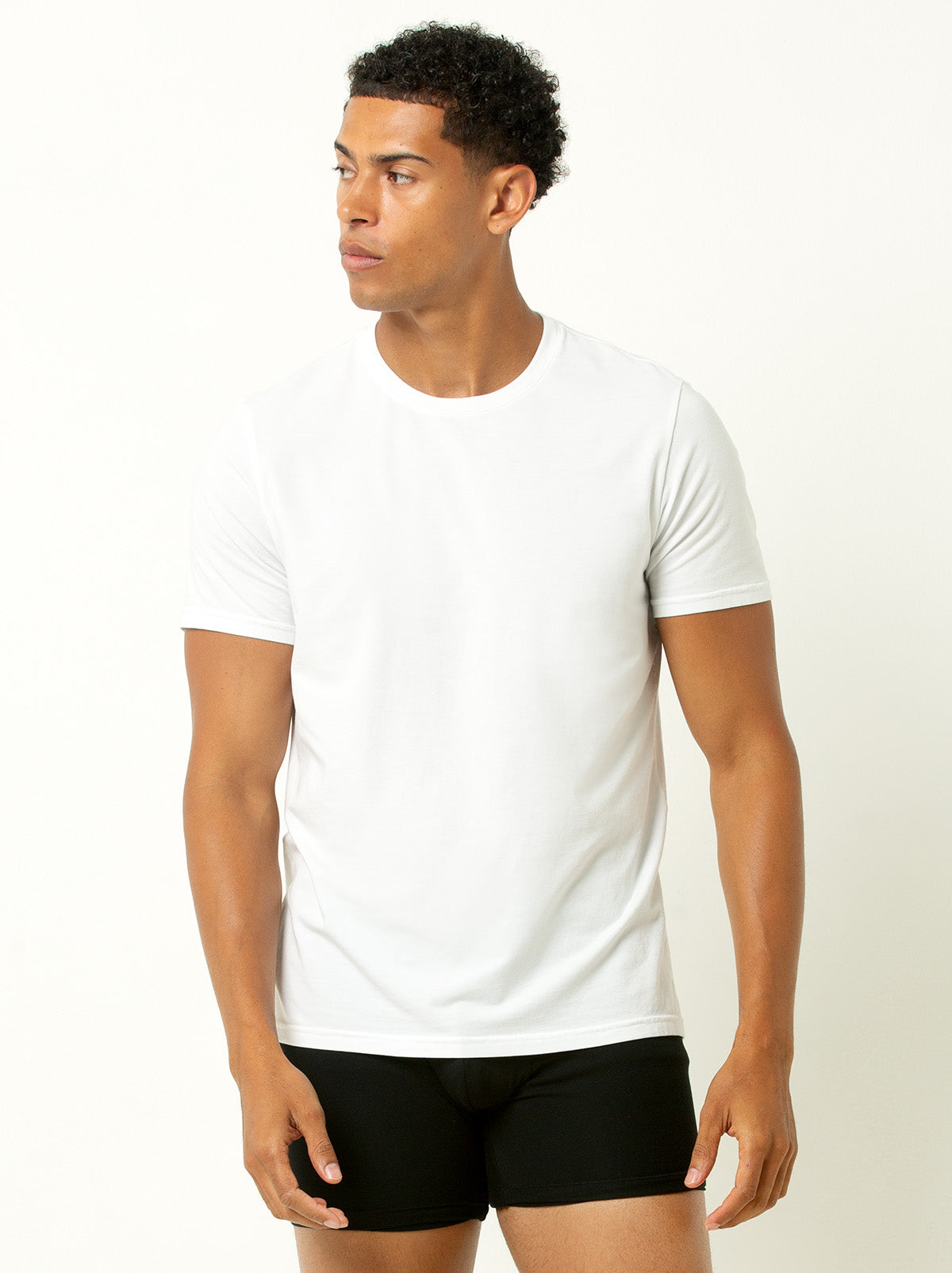 male model wearing a white colored crew neck tee shirt and black underwear