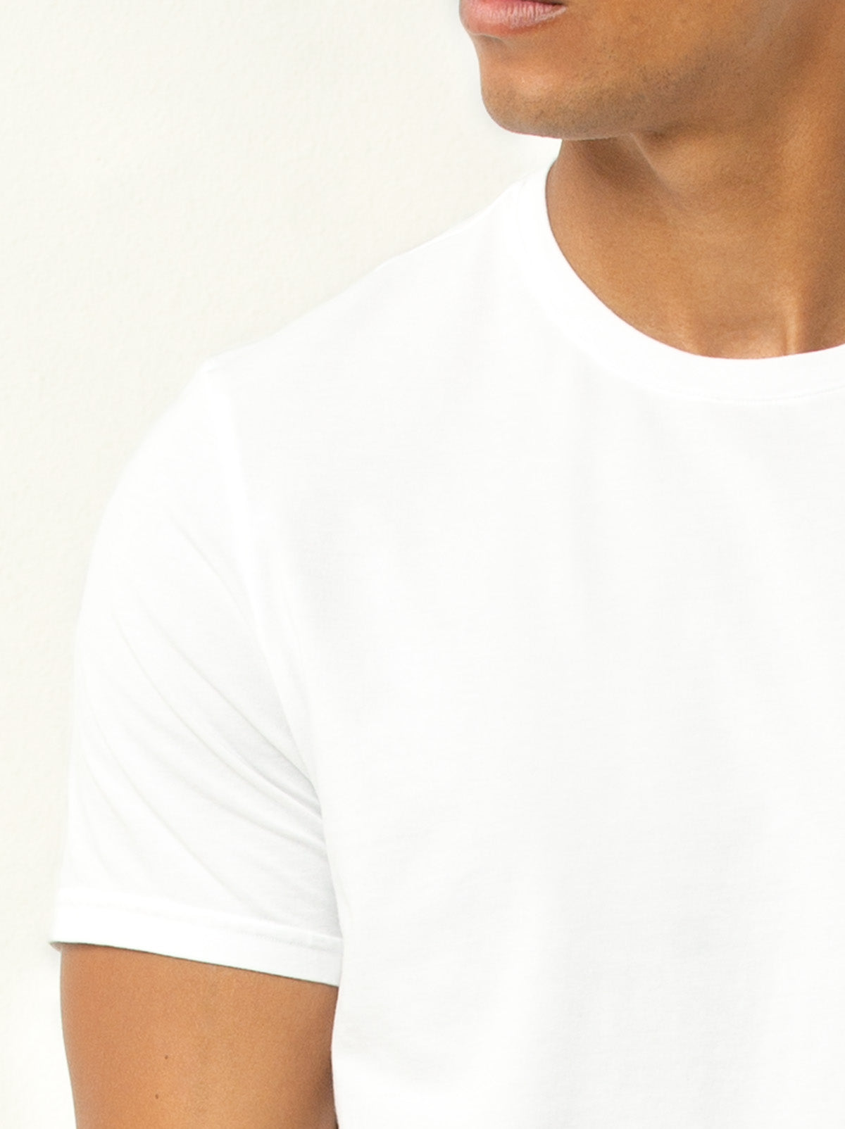 close up shot of male model wearing white colored crew neck tee