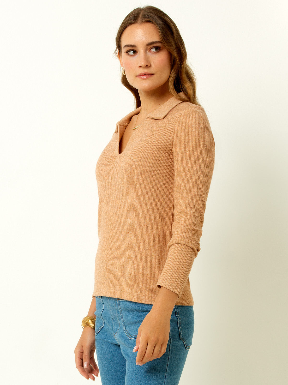 female model waring a macaroon colored v neck sweater with collar 