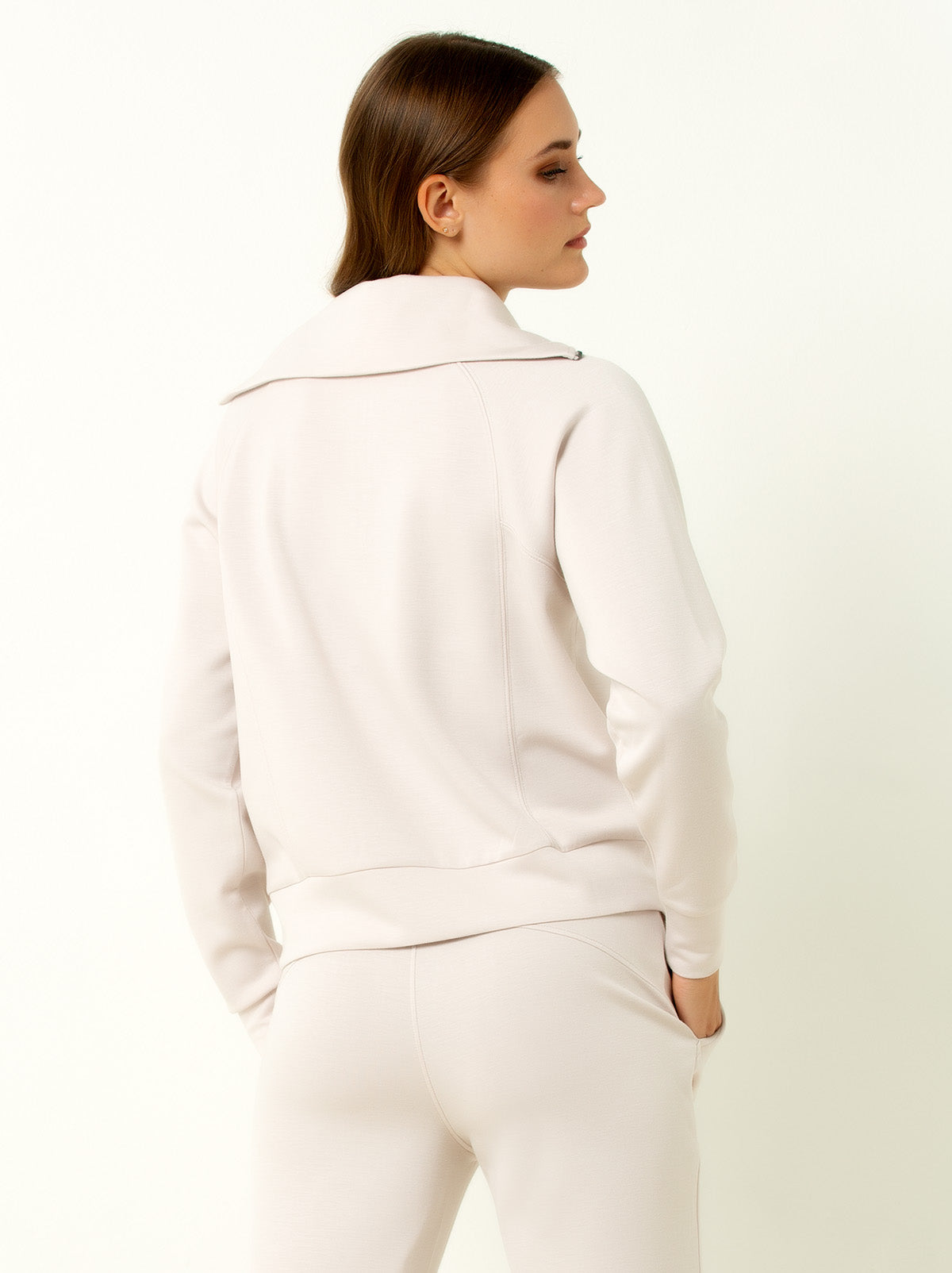 back shot of female model wearing white colored pullover sweatshirt.